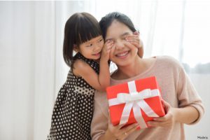Daughter giving her mom a gift