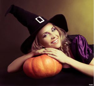 woman resting her head on a pumpkin