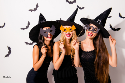 Three women dressed up in black dresses and witch hats