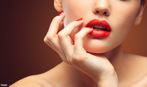 Woman's full lips in red lipstick
