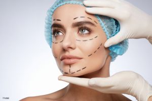 Woman with lines drawn on her face prior to receiving injectables