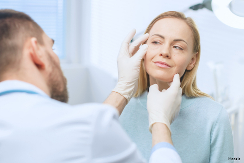 doctor performing a cosmetic procedure on woman